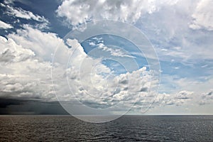 Before the storm. A painted view of storm and rain clouds and the sky above the sea horizon.