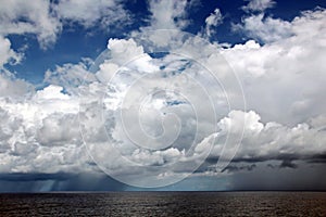 Before the storm. A painted view of storm and rain clouds and the sky above the sea horizon.