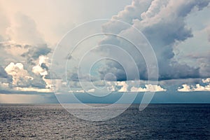 Before the storm. A painted view of storm and rain clouds and the sky above the sea horizon.