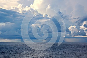 Before the storm. A painted view of storm and rain clouds and the sky above the sea horizon.