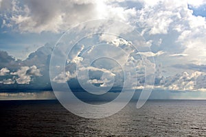 Before the storm. A painted view of storm and rain clouds and the sky above the sea horizon.