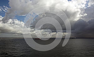 Before the storm. A painted view of storm and rain clouds and the sky above the sea horizon.