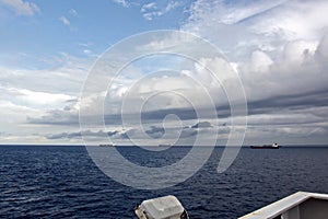 Before the storm. A painted view of storm and rain clouds and the sky above the sea horizon.