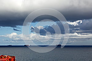 Before the storm. A painted view of storm and rain clouds and the sky above the sea horizon.