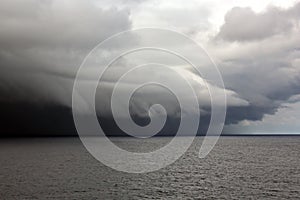 Before the storm. A painted view of storm and rain clouds and the sky above the sea horizon.