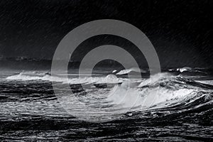 Storm, rain and waves on the beach