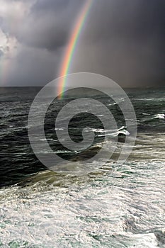 Storm with rainbow and rough sea