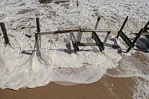 Storm's Sudsy Foam flowing in Debris on the Beach