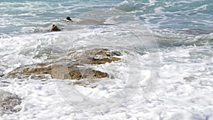 Storm on the sea. Beautiful strong big waves with foam during a summer storm on the Cretan Sea. Waves crash against the