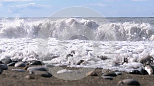 Storm on the Sea. Bottom view of the Stony Shore. Huge Waves are Crashing on the Beach