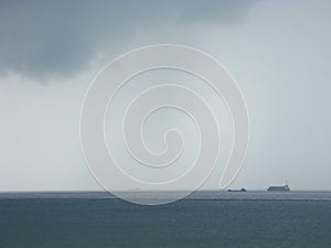 Storm at sea with freighters approaching