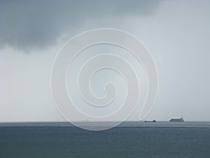 Storm at sea with freighters approaching photo