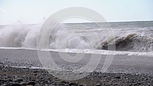 Storm on the Sea. Huge Waves are Crashing and Spraying on the Beach. Slow Motion