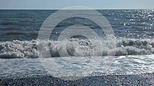 Storm in the sea, sunny summer day. Big waves braking at the beach.