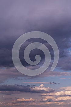 Storm sky. Dark grey, violet and white big cumulus rainy clouds on blue sky background, cloud texture, thunderstorm