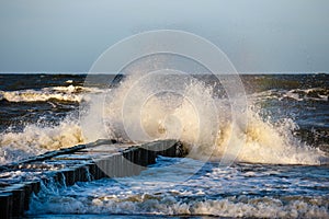 Storm with splash from big waves over pier from the baltic coast