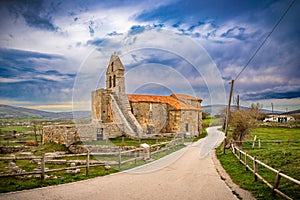 storm and sunset landscape with church in Spain