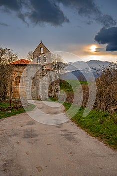 storm and sunset landscape with church in Spain