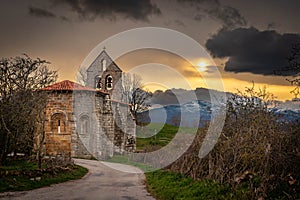 storm and sunset landscape with church in Spain