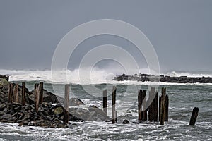Storm surge creates high waves crashing on a jetty