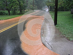 Storm water runoff on road after heavy rain in North Carolina