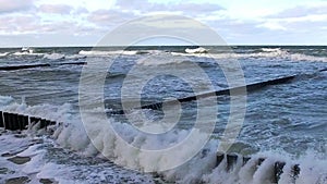 storm waves breaking on breakwaters, after a hurricane on the coast