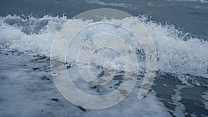 Storm waves crashing sea beach in blue weather nature background aerial view.