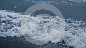 Storm waves crashing sea beach in blue weather nature background aerial view.