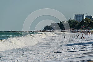 Storm waves and crowded beach