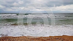 Storm waves of the sea of Azov run over a sandy beach