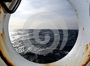 The storming sea viewed through the porthole