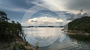 Storms approaching a beautiful lake with hills