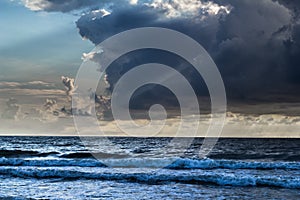 Stormy cloud above the Baltic sea with rays of sun shining throughout