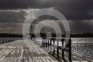 stormy cloud over a pier and lake
