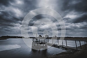 Stormy clouds above old concrete dam in Lithuania