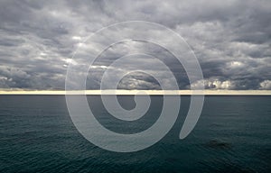 Stormy clouds with dramatic sky above the sea at sunset