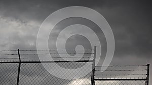 Stormy Clouds and Fence