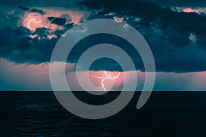 Stormy clouds with lightning over ocean