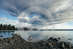 Stormy clouds looming over English Bay, while the West End stands in the distance, seen from the
