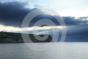 Stormy clouds over The Atlantic shore near Horta, Faial island, Azores Archipelago.