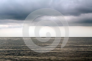 Stormy clouds over sea with rays of sunlight