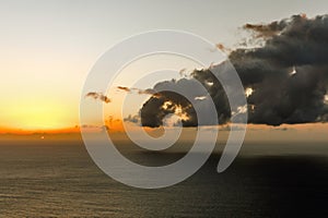 Stormy clouds over the sea during sunset.