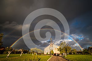 Stormy cloudy rainbow sky in countryside