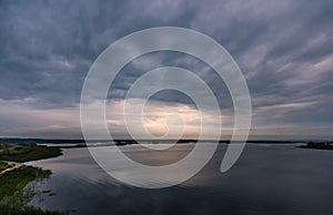 Stormy cloudy sky at sunset over the river Volga photo