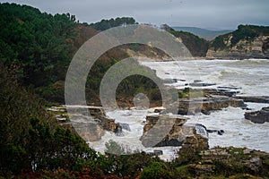 Stormy Coastal Fury: Waves and Rocks Collide