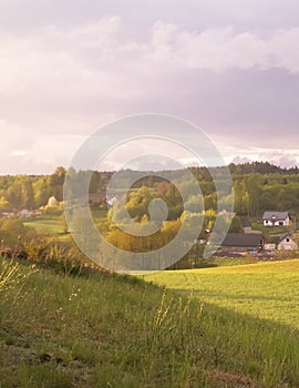 Stormy couds and sunset sky over fields