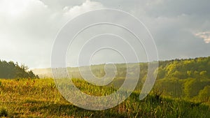 Stormy couds and sunset sky over fields