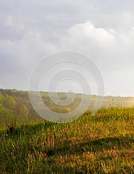 Stormy couds and sunset sky over fields