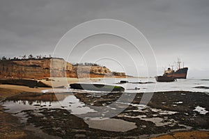 Stormy day at Santiago beach ship graveyard in Luanda, Angola