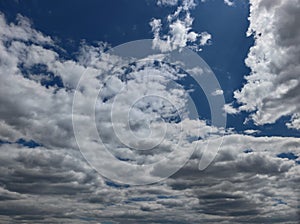 Stormy gray and white clouds. A few spots of dark blue sky inside